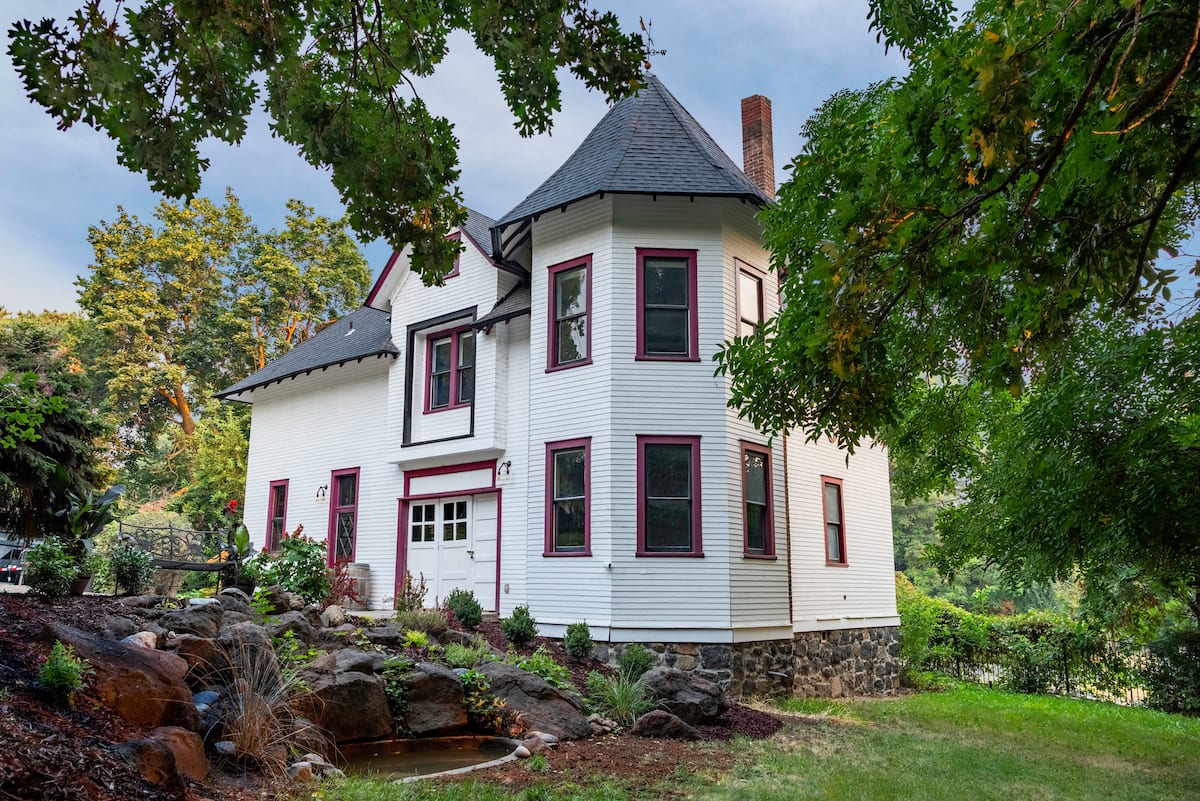 Unit A — Carriage House exterior with garden and pond view